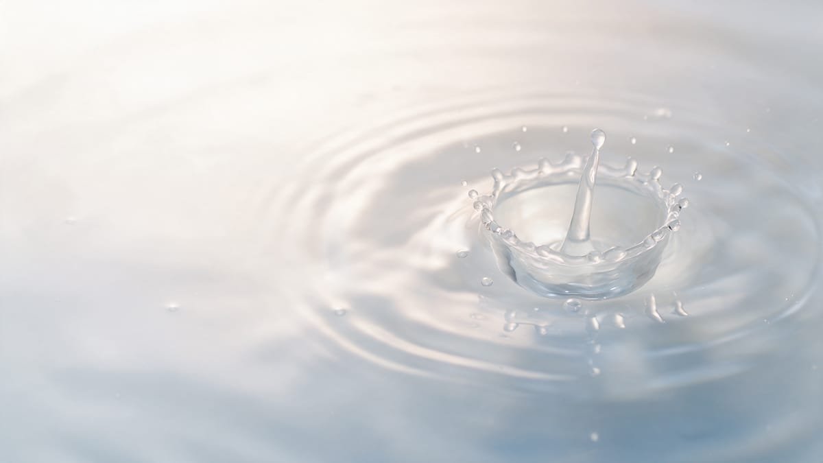 A drop falling onto purified water